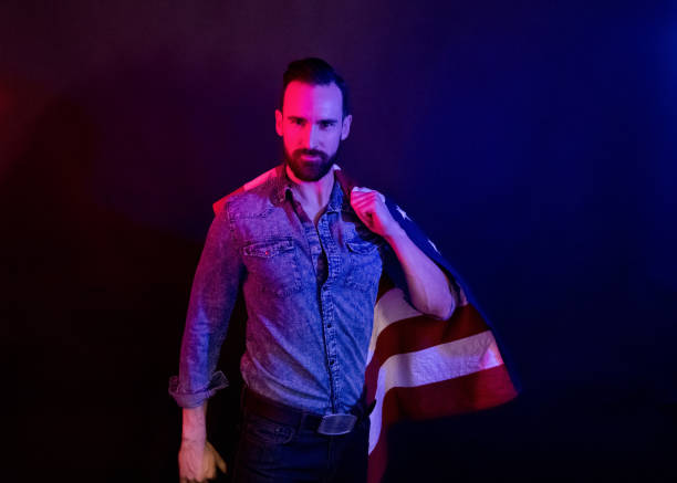 istock Handsome man holding an American flag 1141712723