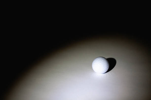 istock Spotlight and golf ball in the dark room. 1141714231