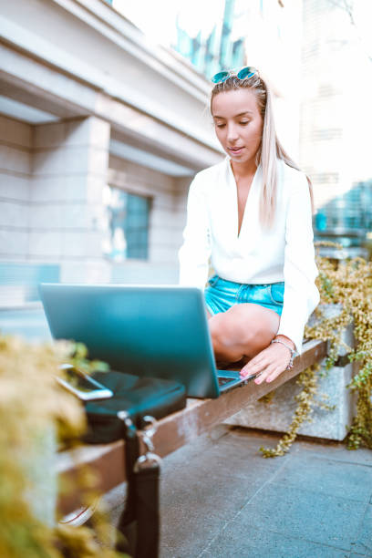 istock Female Relaxing On Bench And Working On Laptop 1141714273