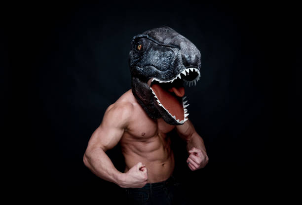 istock Sexy muscular man wearing a dinosaur mask 1141714453