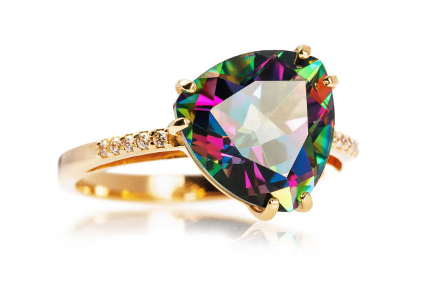 istock Golden ring with a large stone iridescent with various colors and diamonds, isolated on a white background 1141716131