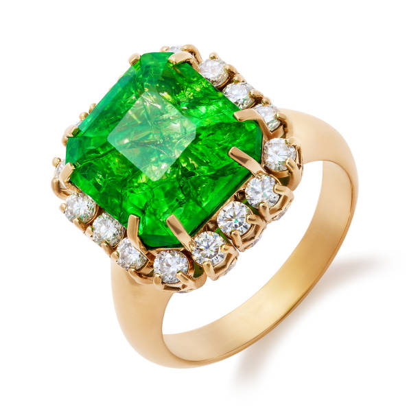 istock Golden ring with big emerald and diamonds isolated on white background 1141716204