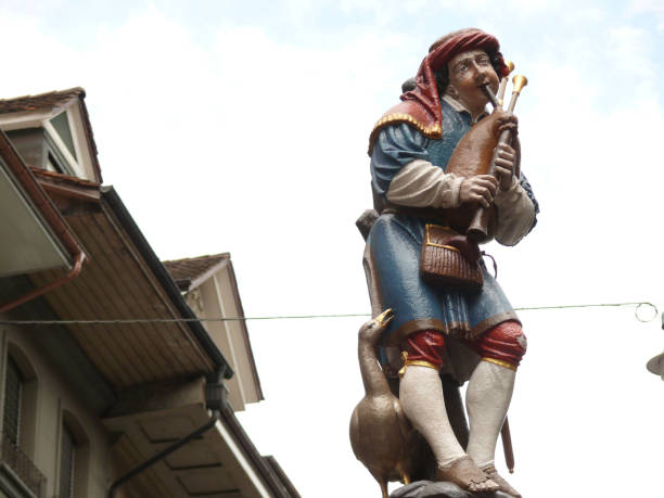 istock Colorful statue with bagpipe player and goose. 1141717899