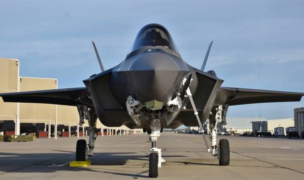 Close-up of F-35 Fighter jet aircraft flying at sunset.