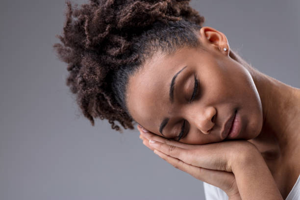 istock Tired young woman dozing with head on hands 1141723082