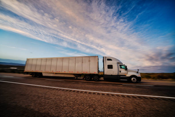 istock Long Haul Semi Truck on a Highway at Dusk under a Dramatic Sky 1141726184