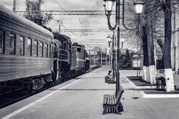 Blurred background of traditional rural train station and railway track without people. Transportation system background photo.