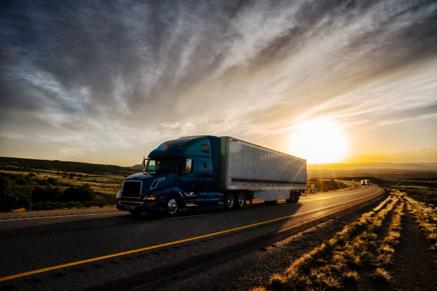 istock Long Haul Semi Truck on a Highway at Dusk under a Dramatic Sky 1141726633