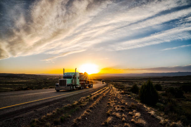 istock Long Haul Semi Truck on a Highway at Dusk under a Dramatic Sky 1141726636