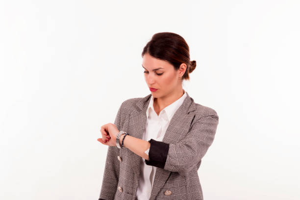 istock Gorgeous girl looking at the clock.White background. 1141728234