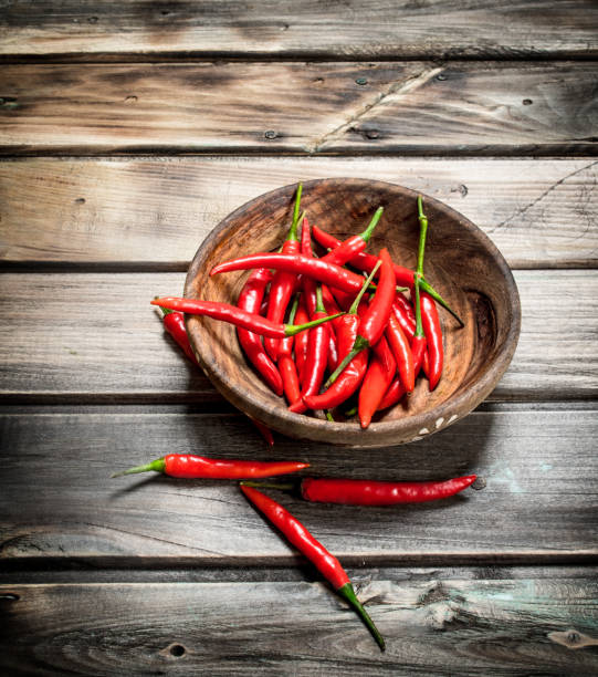 istock Fresh ripe red pepper in wooden bowl. 1141728281
