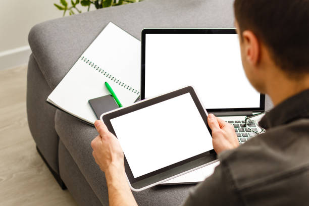 istock Young man working on his laptop with blank copy space screen for your advertising text message in office, Back view of business man hands busy using laptop at office desk 1141729213