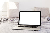 The laptop and computer in the morning on a white pillow bed. Lifestyle Concept