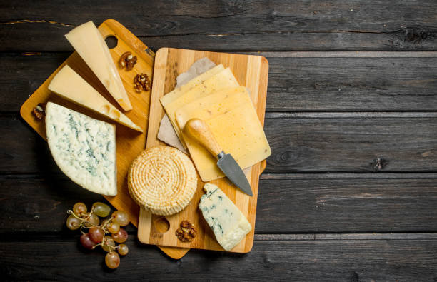 istock Assortment of different cheeses with grapes and walnuts. 1141729531