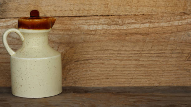 istock creamer pitcher on wood background 1141729635