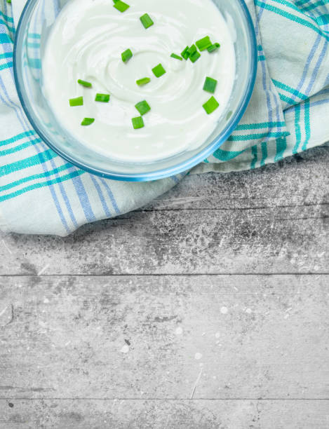 istock Sour cream in bowl with green onions. 1141730156