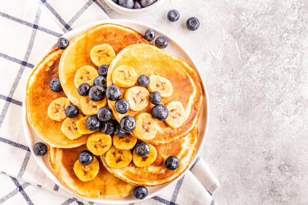 istock Pancakes with banana,  blueberries on white plate 1141731239
