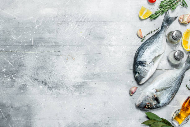 istock Raw sea fish with lemon wedges and spices. 1141732583