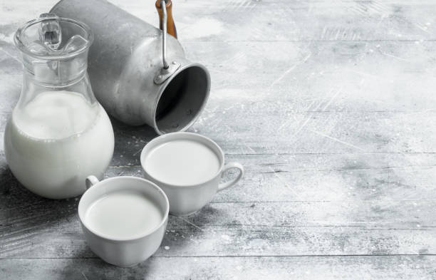istock Milk in mugs with a can. 1141732646