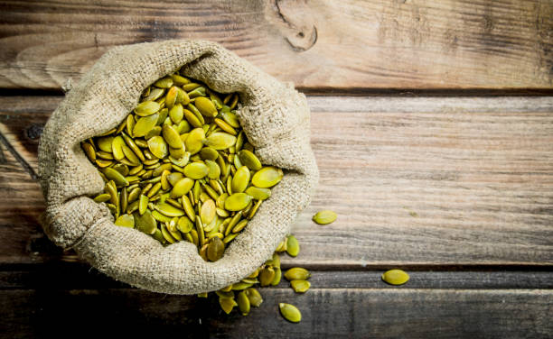 istock Pumpkin seeds in a bag. 1141732651