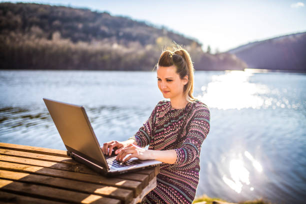istock Working on the laptop by lake 1141732938
