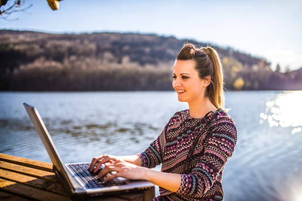 istock Working on the laptop by lake 1141732959