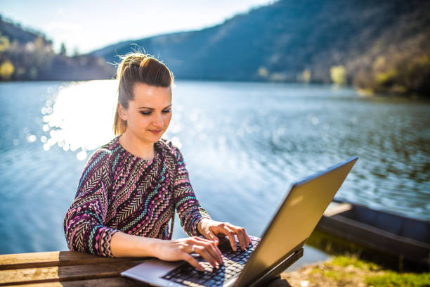 istock Working on the laptop by lake 1141732996