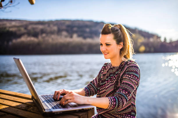istock Working on the laptop by lake 1141733052