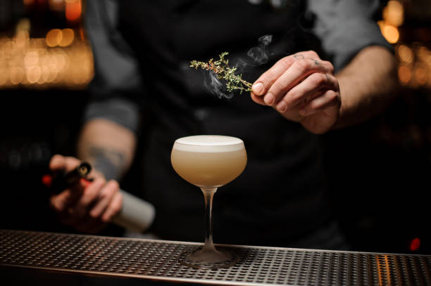 istock Bartender adding to a cocktail in the glass smoked herb 1141733272