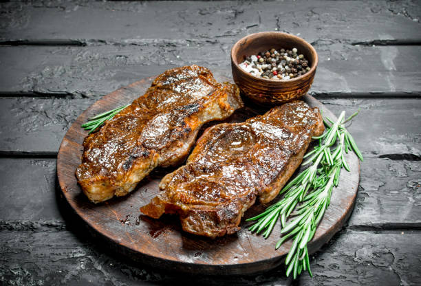 istock Grilled beef steaks with spices and herbs. 1141733815