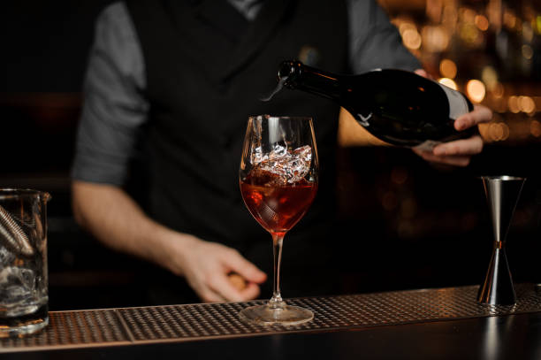 istock Bartender adds sparkling wine in cocktail on a bar counter 1141734019