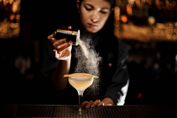istock Bartender girl holding a spice shaker adding to a delicious cocktail flavours 1141734073