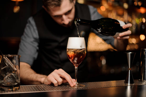 istock Bartender mixing a delicious cocktail pouring alcohol from the bottle 1141734294