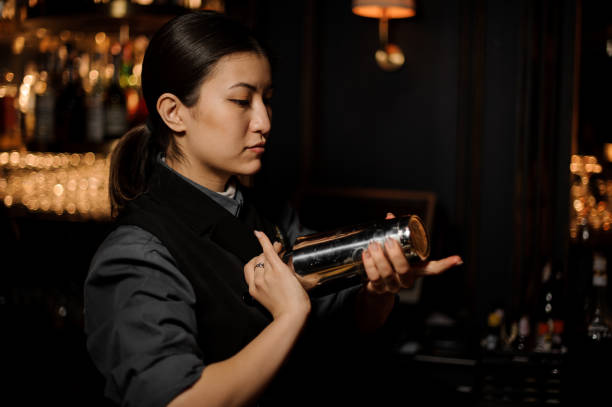 istock Bartender pours an alcohol cocktail in glass 1141734449