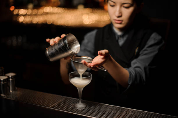 istock Bartender pours an alcohol cocktail in glass 1141734467