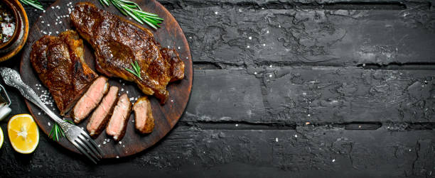 istock Grilled beef steaks on a cutting Board. 1141734626