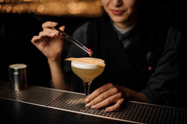 istock Bartender pours an alcohol cocktail in glass 1141734638