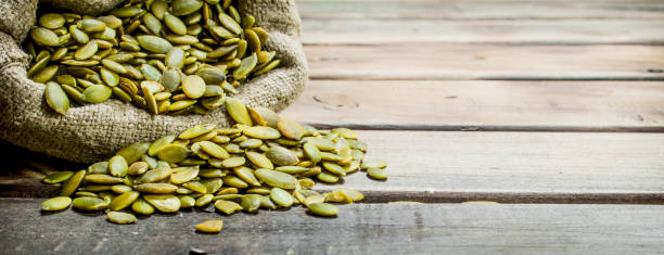 istock Pumpkin seeds in a bag. 1141735689