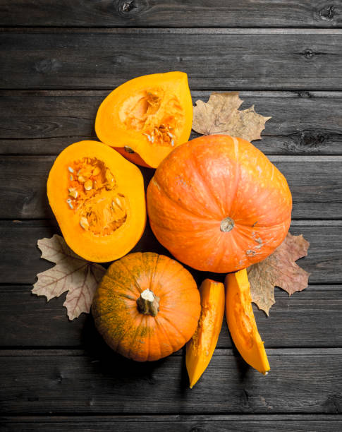 istock Pieces of fragrant pumpkin with leaves. 1141735986