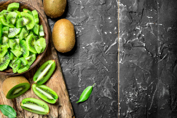 istock Kiwi slices in a bowl on a cutting Board. 1141736385