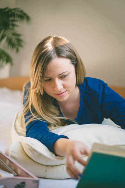 istock Beautiful woman lying in bed 1141737219