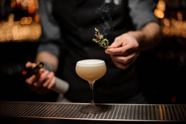 istock Professional bartender adding to a cocktail in the glass smoked herb 1141737226