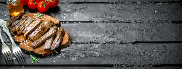 istock Grilled beef steak with spices and tomatoes. 1141737322