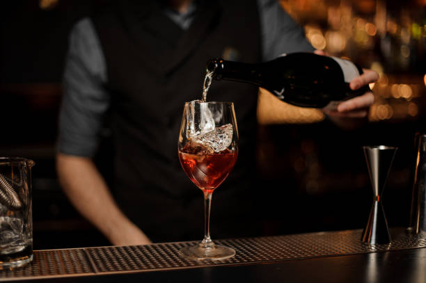 istock Professional bartender mixing a delicious cocktail pouring alcohol from the bottle 1141737538