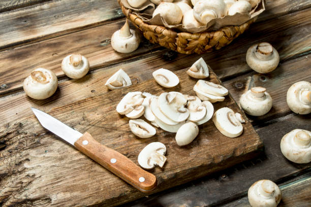istock Cut mushrooms on a cutting Board with a knife. 1141737719