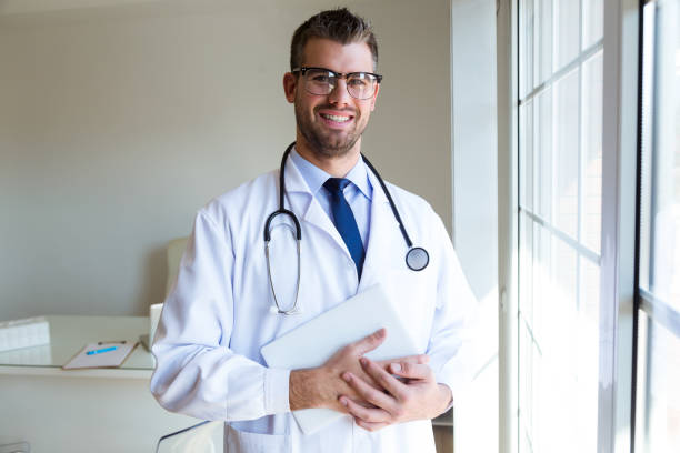 istock Confident male doctor in the office looking at camera. 1141744064