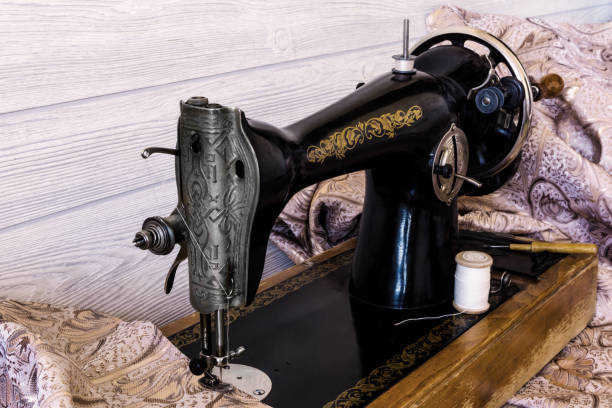 istock antique sewing machine and fabrics 1141744315