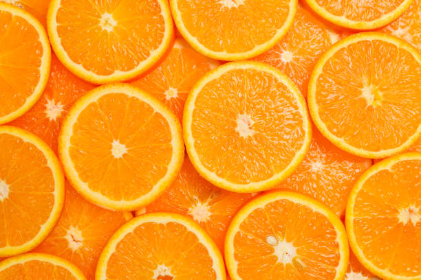 istock Slices of oranges as a background, top view. 1141744612