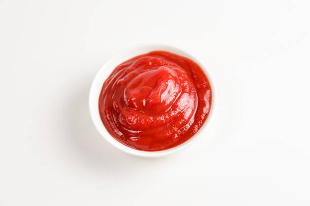 istock Ketchup in white plate on white background. 1141744813