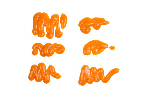 istock Orange sauce splashes isolated on white background 1141744814